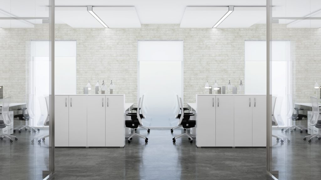 A modern office meeting room with epoxy flooring viewed through a glass partition. The room features a long white conference table with surrounding chairs, flanked by white storage cabinets. Symmetry is evident in the room's layout, with a backdrop of a brick-textured wall and large windows allowing natural light to complement the room's sleek, minimalist design.